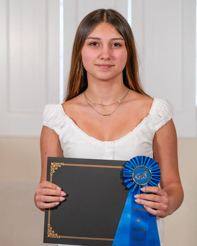 Rebecca Hanes poses with her award